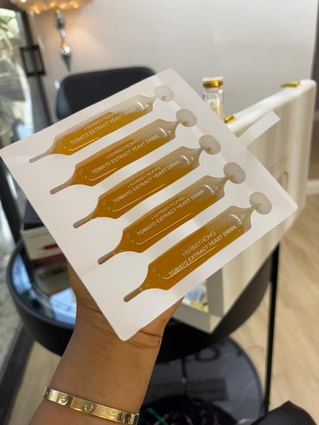 Hand holding a tray of tomato yeast ampoules